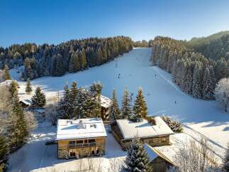 Discover a charming chalet nestled in a winter wonderland, offering a perfect blend of rustic charm and modern comfort.