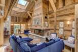 Experience the epitome of luxury living in this stunning property, featuring a cozy living room with a grand fireplace, perfect for creating a warm and inviting atmosphere.