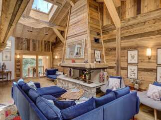 Experience the epitome of luxury living in this stunning property, featuring a cozy living room with a grand fireplace, perfect for creating a warm and inviting atmosphere.
