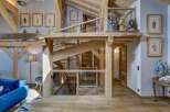 Step into luxury with this stunning property featuring a unique wooden staircase and exposed beams, creating a warm and inviting atmosphere.