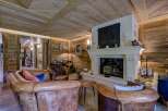 Step into luxury with this stunning living space, featuring a cozy fireplace and exquisite wooden accents.