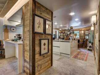 This stunning kitchen boasts a rustic charm with its wooden accents and modern amenities.