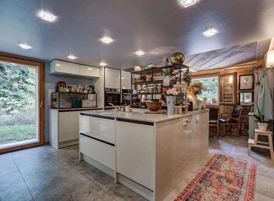 This stunning kitchen boasts a modern design with sleek cabinetry and a spacious island, perfect for culinary enthusiasts.