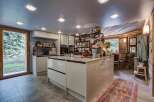 This stunning kitchen boasts a modern design with sleek cabinetry and a spacious island, perfect for culinary enthusiasts.