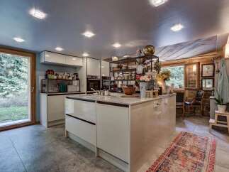 This stunning kitchen boasts a modern design with sleek cabinetry and a spacious island, perfect for culinary enthusiasts.