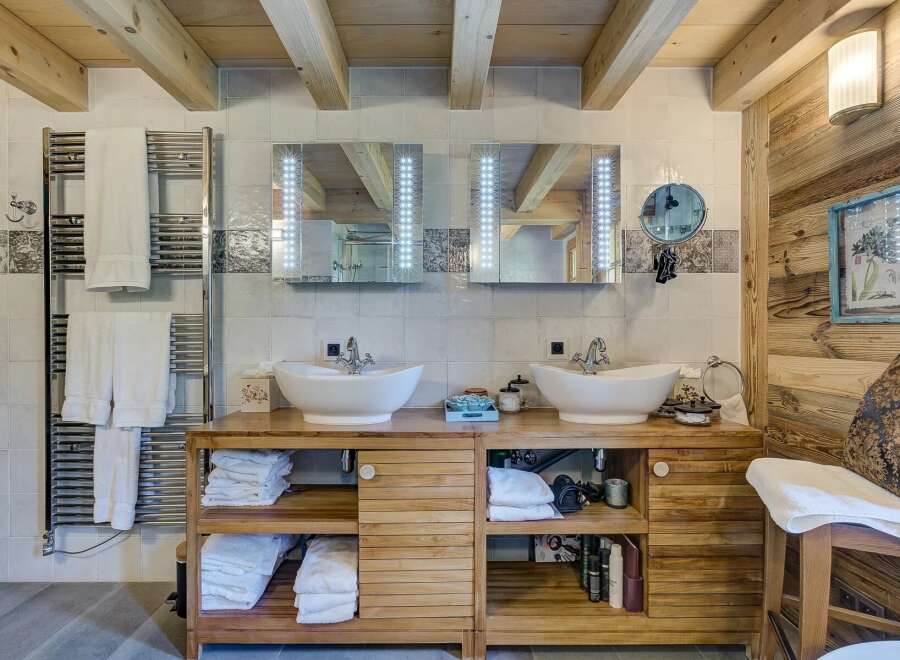 This luxurious bathroom boasts a rustic charm with its wooden accents and modern amenities.