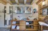 This luxurious bathroom boasts a rustic charm with its wooden accents and modern amenities.