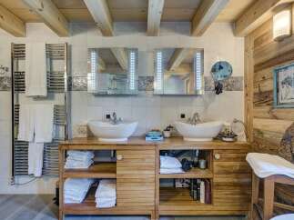 This luxurious bathroom boasts a rustic charm with its wooden accents and modern amenities.