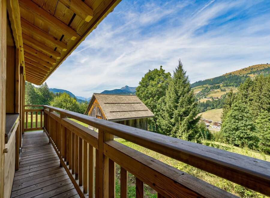 Enjoy breathtaking mountain views from this charming wooden balcony.