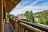 Enjoy breathtaking mountain views from this charming wooden balcony.