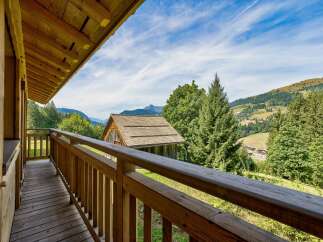 Enjoy breathtaking mountain views from this charming wooden balcony.