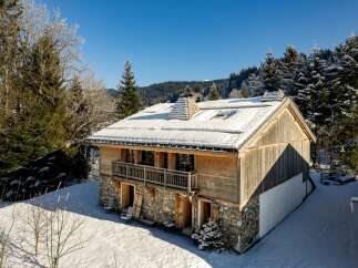 Discover the charm of this stunning chalet nestled in a winter wonderland.
