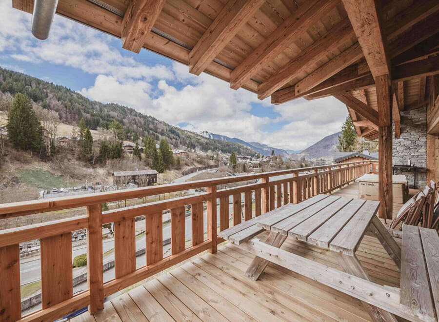 Enjoy breathtaking mountain views from this charming chalet balcony.