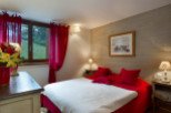 Cozy bedroom with a mountain view and red accents.