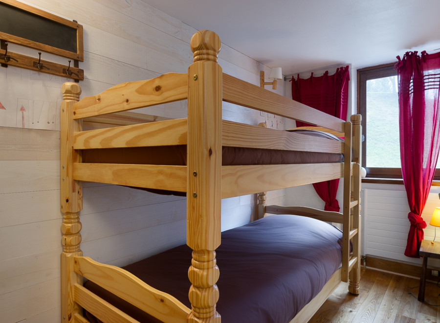Cozy bunk beds in a charming wooden room, perfect for a family getaway.