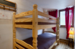 Cozy bunk beds in a charming wooden room, perfect for a family getaway.