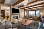 Experience luxury living in this stunning property featuring a cozy fireplace and a modern entertainment setup.