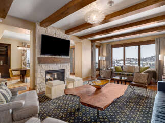 Experience luxury living in this stunning property featuring a cozy fireplace and a modern entertainment setup.