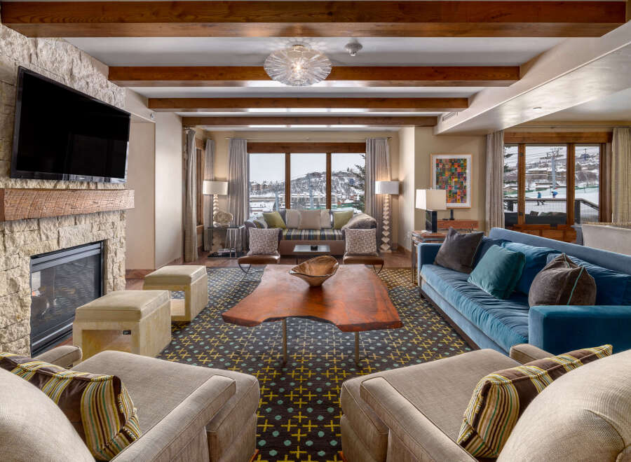 Experience luxury living in this stunning property, featuring a cozy fireplace and a modern entertainment setup.