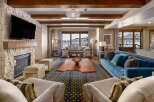 Experience luxury living in this stunning property, featuring a cozy fireplace and a modern entertainment setup.