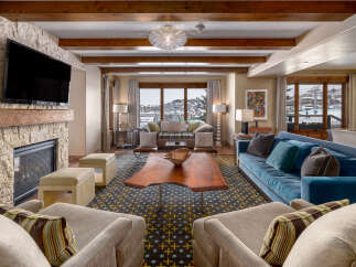 Experience luxury living in this stunning property, featuring a cozy fireplace and a modern entertainment setup.