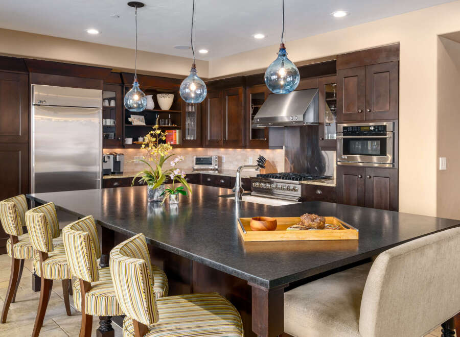 This stunning kitchen boasts a spacious island with ample seating, perfect for entertaining or casual dining.