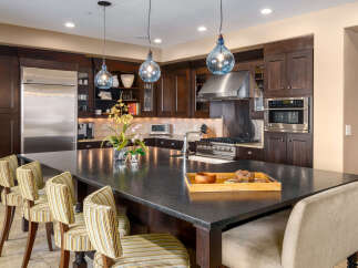 This stunning kitchen boasts a spacious island with ample seating, perfect for entertaining or casual dining.