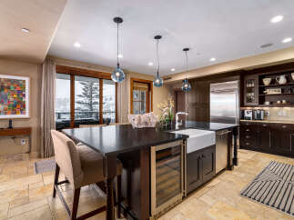 This stunning kitchen boasts a modern design with high-end appliances and finishes.