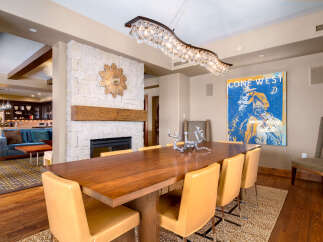 This stunning dining room showcases a beautiful blend of modern and rustic design elements.