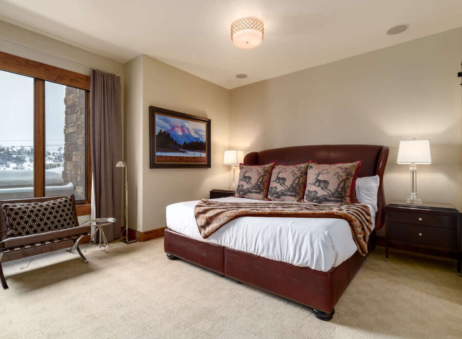 Step into luxury with this stunning bedroom, featuring a plush leather bed and elegant decor.