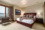 Step into luxury with this stunning bedroom, featuring a plush leather bed and elegant decor.