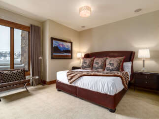 Step into luxury with this stunning bedroom, featuring a plush leather bed and elegant decor.