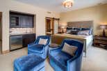 Step into luxury with this stunning bedroom, featuring a private wet bar and elegant seating area.