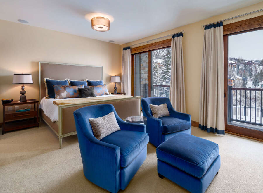 This luxurious bedroom offers a serene retreat with stunning views.
