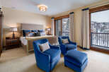 This luxurious bedroom offers a serene retreat with stunning views.