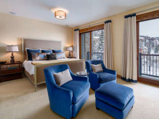 This luxurious bedroom offers a serene retreat with stunning views.