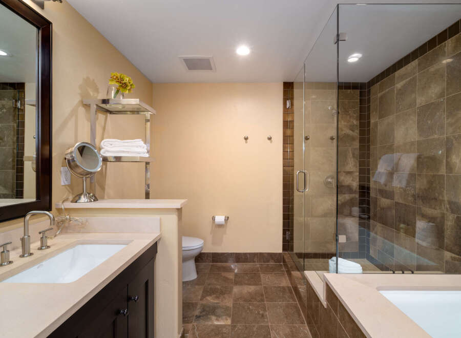 Step into luxury with this stunning bathroom featuring a sleek glass shower and elegant tile work.