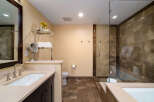 Step into luxury with this stunning bathroom featuring a sleek glass shower and elegant tile work.