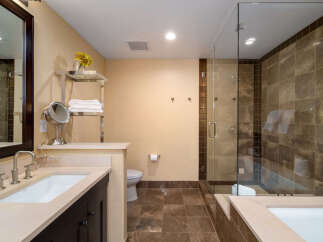 Step into luxury with this stunning bathroom featuring a sleek glass shower and elegant tile work.