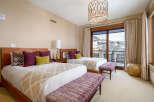 Experience luxury in this stunning bedroom featuring two comfortable beds with plush bedding and stylish accent pillows.