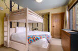 This charming bedroom features a cozy bunk bed, perfect for accommodating guests or family members.