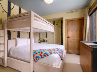 This charming bedroom features a cozy bunk bed, perfect for accommodating guests or family members.