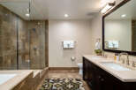 Step into luxury with this stunning bathroom featuring a spacious walk-in shower with elegant tile work.