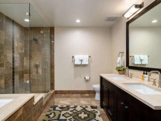 Step into luxury with this stunning bathroom featuring a spacious walk-in shower with elegant tile work.