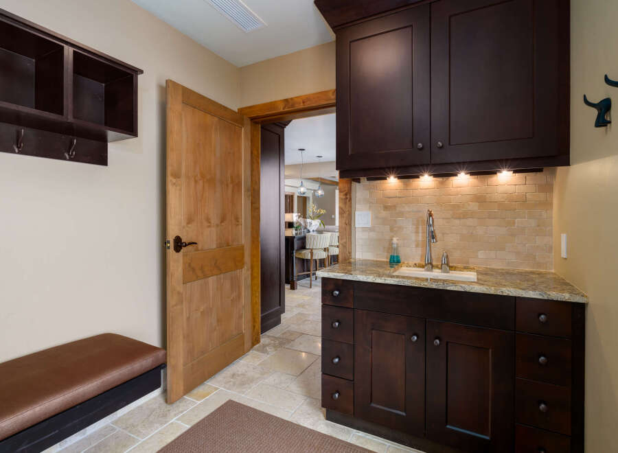 This stunning property boasts a beautifully designed mudroom, perfect for keeping your home organized.