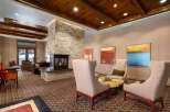 Step into luxury with this stunning property, featuring a cozy fireplace and elegant seating areas.