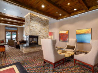 Step into luxury with this stunning property, featuring a cozy fireplace and elegant seating areas.