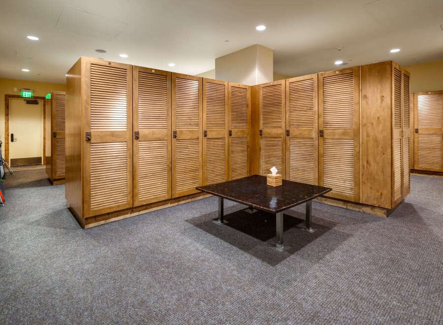 This ski locker room offers ample storage for equipment, featuring numerous wooden lockers with a classic design.