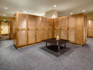 This ski locker room offers ample storage for equipment, featuring numerous wooden lockers with a classic design.