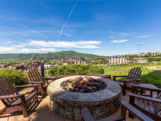 Enjoy breathtaking mountain views from this stunning outdoor fire pit area.
